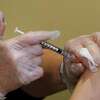 Registered nurse Allison Miller gives one of the first COVID-19 vaccinations at UW Medicine Tuesday, Dec. 15, 2020, in Seattle. (AP Photo/Elaine Thompson)