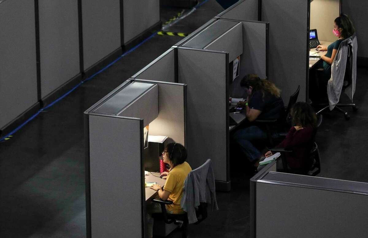 People work in the Contact Monitoring and Contact Tracing Unit of the Houston Health Department on Friday, July 17, 2020, at the George R. Brown Convention Center in Houston.