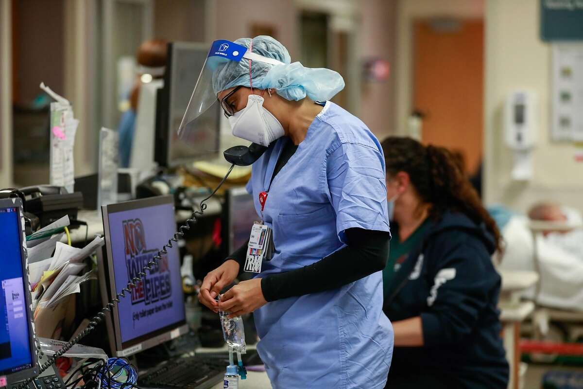 A nurse takes a phone call in the emergency room at Regional Medical Center of San Jose. The availability of Bay Area intensive care unit beds dropped to 12.9% on Tuesday, triggering California’s regional stay-at-home order.