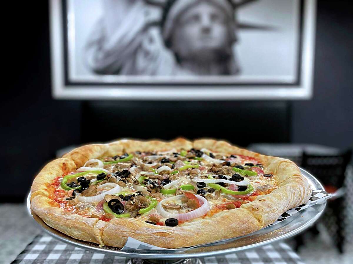 The Fat Bastard pizza includes sausage, beef, ham, green peppers, black olives, onions and mushrooms at Goodfellas Famous NY Pizza on Jefferson Street in downtown San Antonio.