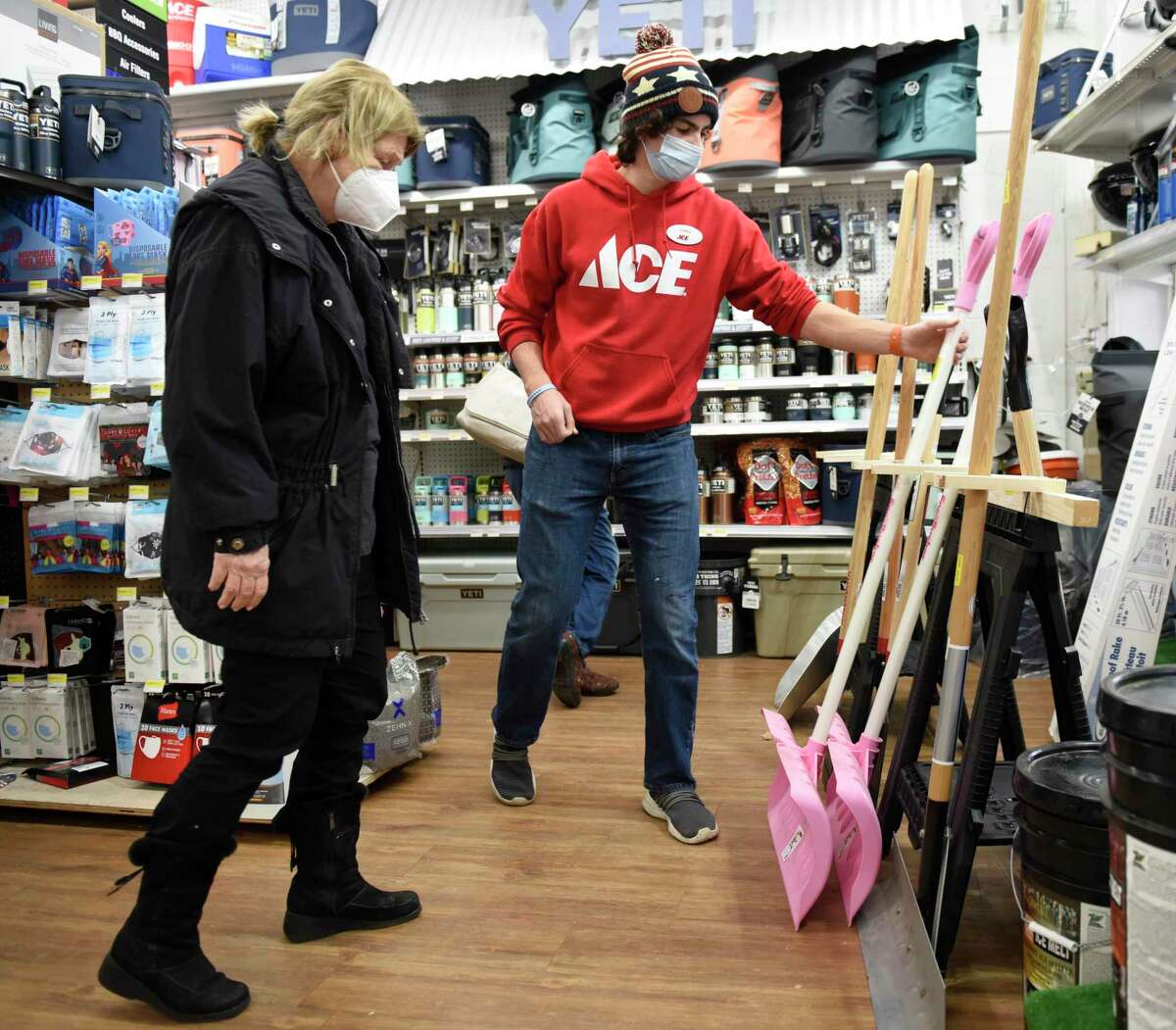 Store associate Chris Cosenza helps Old Greenwich resident Julie Tulipane pick out a shovel at Feinsod Ace Hardware in Old Greenwich, Conn. Wednesday, Dec. 16, 2020. Folks stocked up on shovels, ice melt, and groceries in anticipation of the winter storm expected to dump more than a foot of snow starting Wednesday night.
