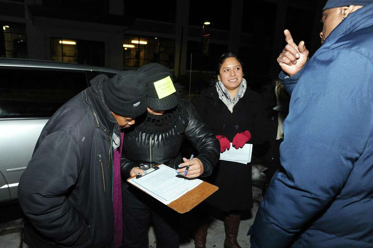 Volunteers gather information from Cynthia Jones, left, as part of the annual Point in Time, a nation-wide count of sheltered and unsheltered homeless persons on Tuesday, Jan. 26, 2016.