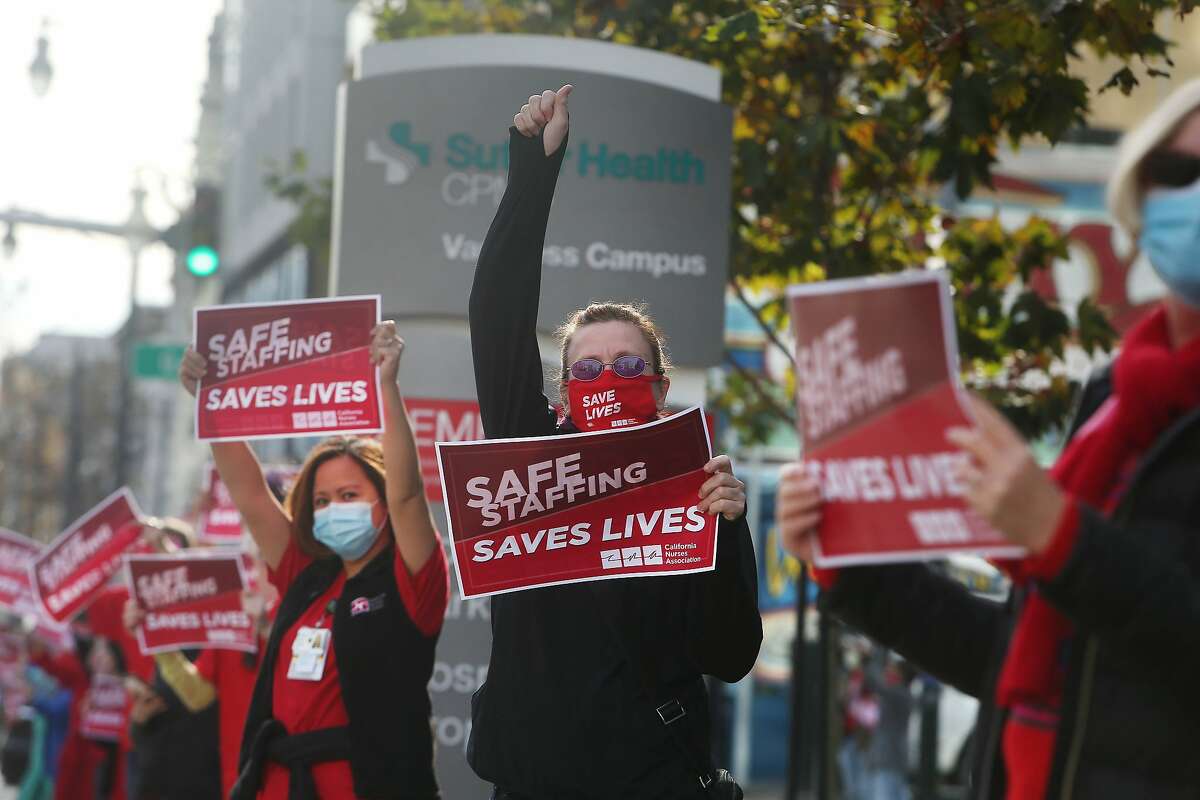 Deanna Young (center), nurse at California Pacific’s Mission Bernal campus, and others protest the waivers.