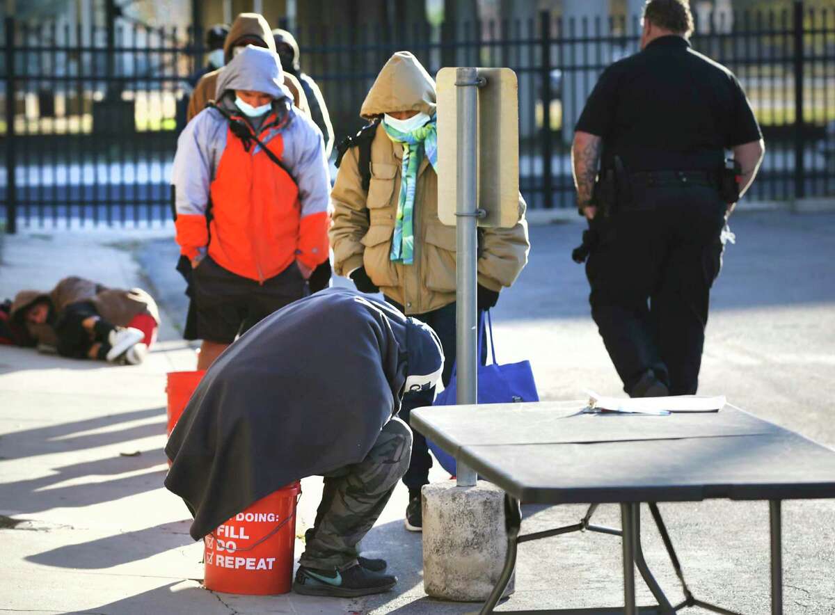 Homeless wait at Christian Assistance Ministry for a meal, on Wednesday, Dec. 16, 2020. The City Council will be reviewing the city's 5-year plan to reduce homelessness.