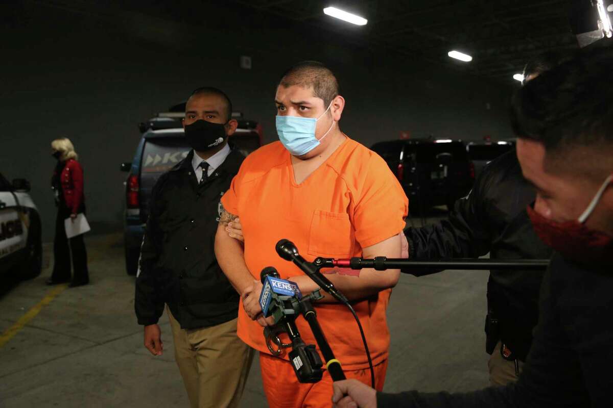 Rafael Castillo, 26, is led into the Bexar County Jail, Wednesday, Dec. 16, 2020. Castillo has been charged in the murder of Nicole Perry, 31. Perry's body was found was found wrapped in a tarp by a cleaning crew on S. WW White Road on Nov. 19. Castillo was arrested by the Lone Star Fugitive and the Gulf Coast Violent Offenders task forces at a relative?•s house in Brownsville, Texas. They believe he killed Perry, with a hatchet or axe, at a home on West Harlan Avenue. They are still searching for body parts.