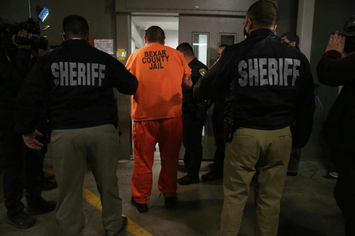 Rafael Castillo, 26, is led into the Bexar County Jail, Wednesday, Dec. 16, 2020. Castillo has been charged in the murder of Nicole Perry, 31. Perry's body was found was found wrapped in a tarp by a cleaning crew on S. WW White Road on Nov. 19. Castillo was arrested by the Lone Star Fugitive and the Gulf Coast Violent Offenders task forces at a relative?•s house in Brownsville, Texas. They believe he killed Perry, with a hatchet or axe, at a home on West Harlan Avenue. They are still searching for body parts.