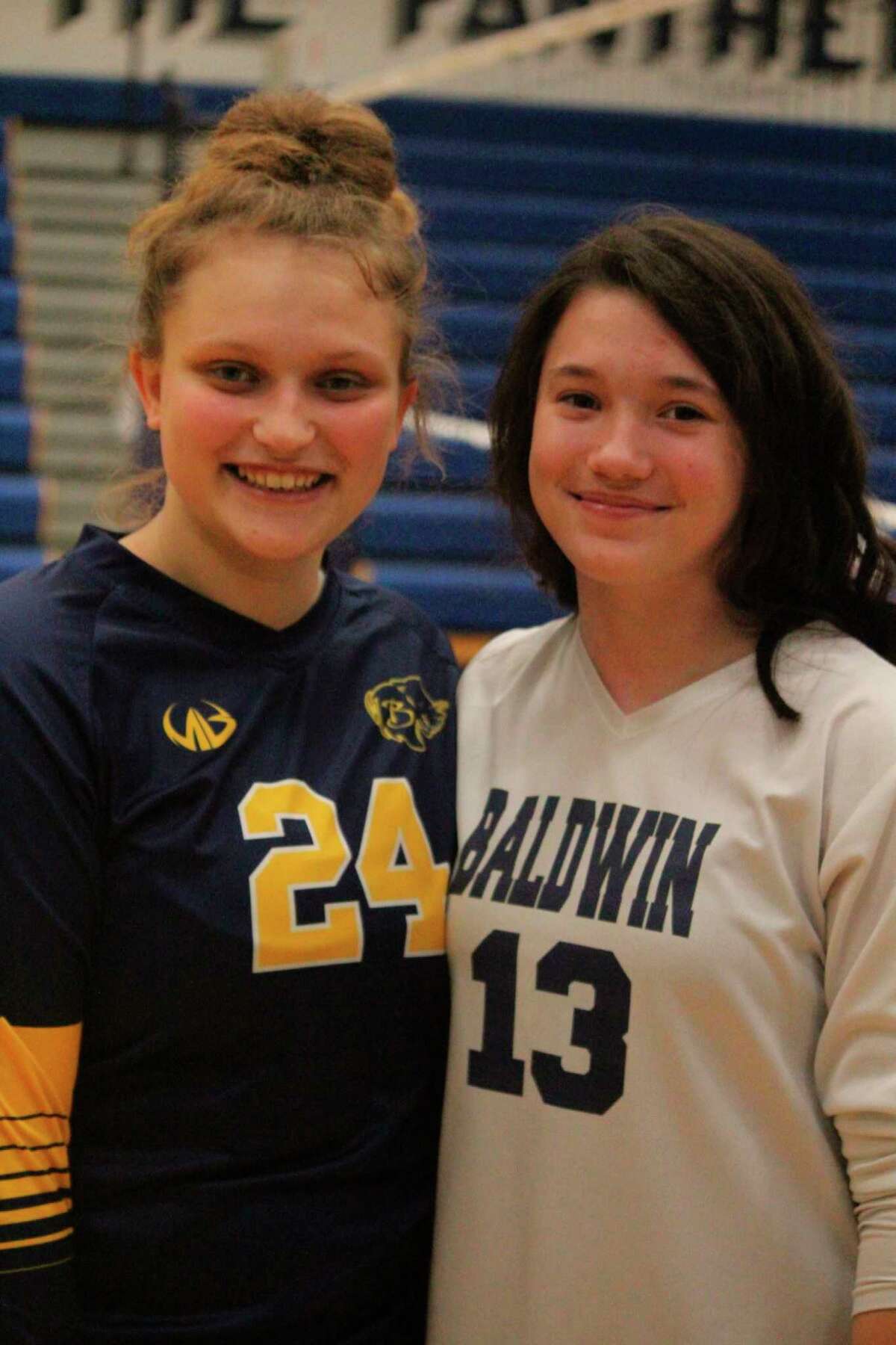 Baldwin's Abby Oisten (24) and Penelope Lapham celebrate a win during the 2020 season. (Star photo/John Raffel)