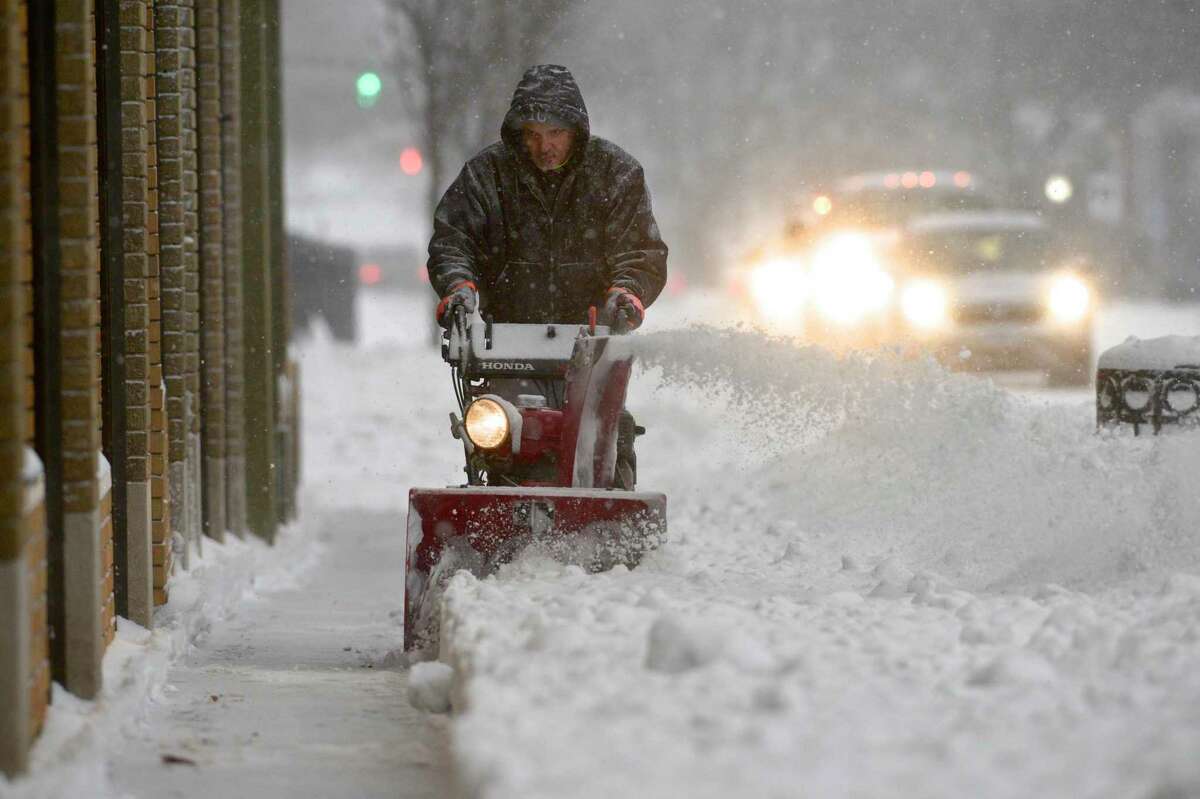 Marselo Gregorino makes a second pass with a snow blower along West Street as he cleared a sidewalk early Thursday morning. A nor'easter was expected to drop a foot or more of snow over the area. December 17, 2020, in Danbury, Conn.