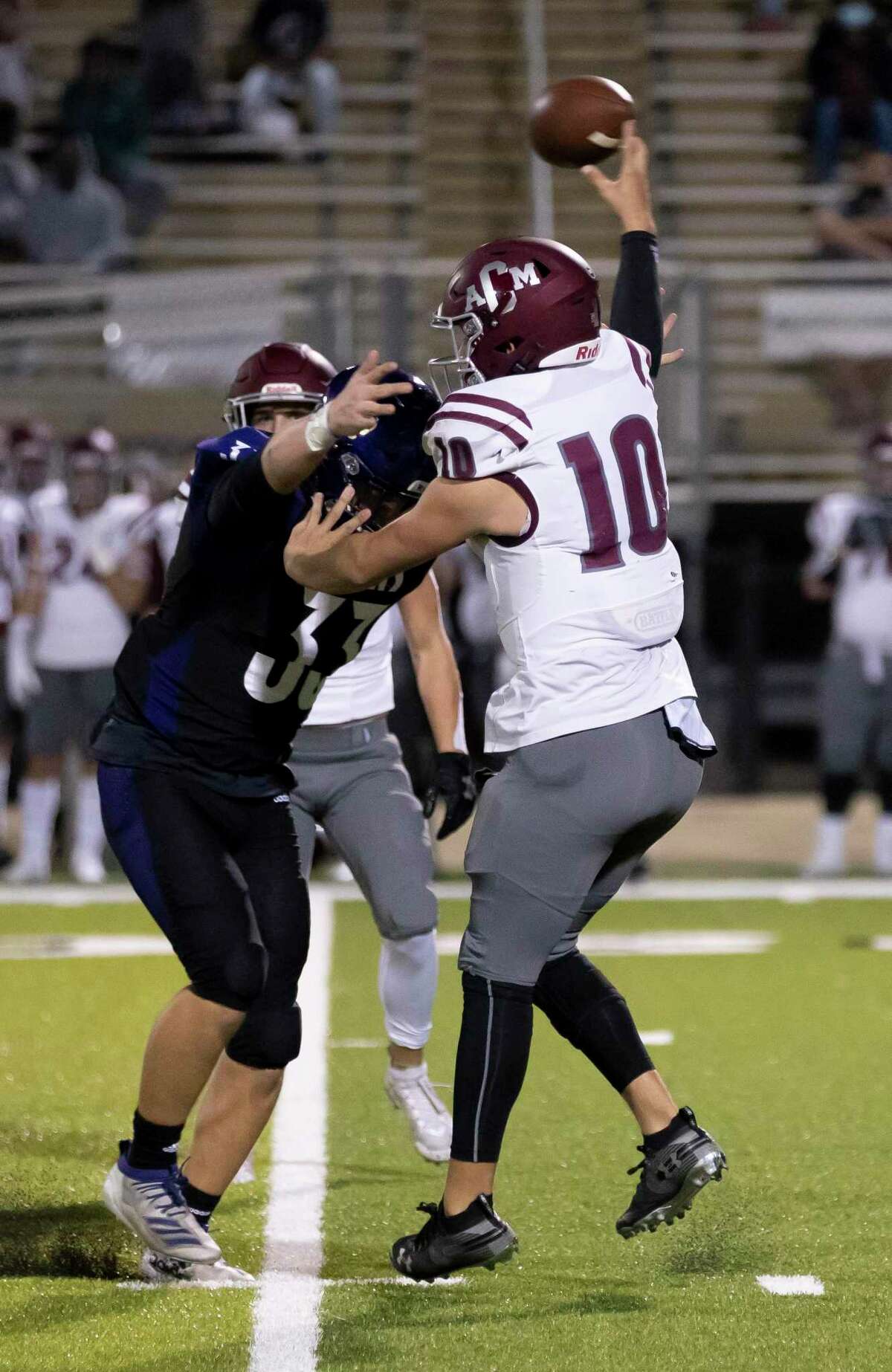 A&M Consolidated player Kyle Willis (10) throws a pass while under pressure from Montgomery defensive tackle Cameron Middleton (33) during the first quarter of a District 10-5A (Div. II) football game at Montgomery ISD Stadium on Friday, Nov. 13, 2020.