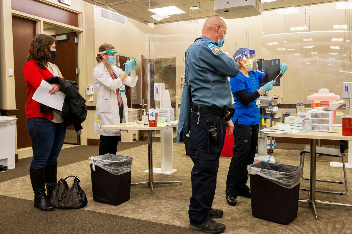 A public safety officer prepares to receive his vaccination shot at Backus Hospital where 211 doses of the Pfizer BioNTech Covid-19 vaccine were delivered and being given to 30 hospital workers on the first day of vaccinations in Norwich, Connecticut on December 15, 2020. (Photo by Joseph Prezioso / AFP) (Photo by JOSEPH PREZIOSO/AFP via Getty Images)