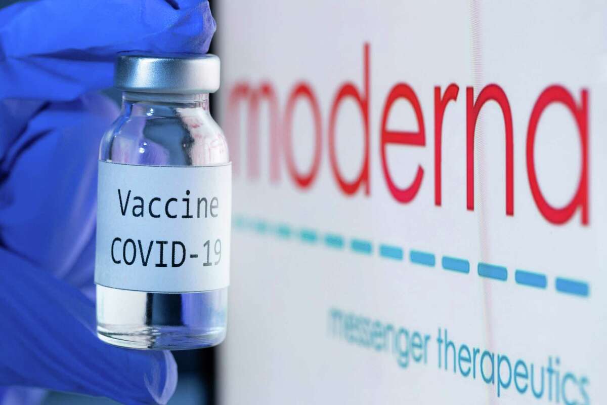 This file photo taken on Nov. 18, 2020 shows a bottle reading "Vaccine Covid-19" next to the Moderna biotech company logo.
