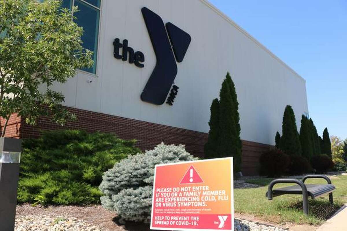 A sign outside the Edwardsville Meyer Center YMCA warns of COVID-19 restrictions
