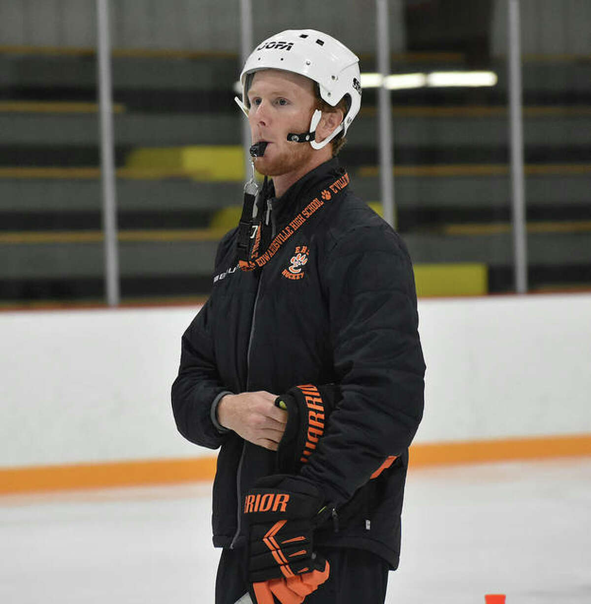 Edwardsville coach Jason Walker watches an August practice from center ice at the East Alton Ice Arena.