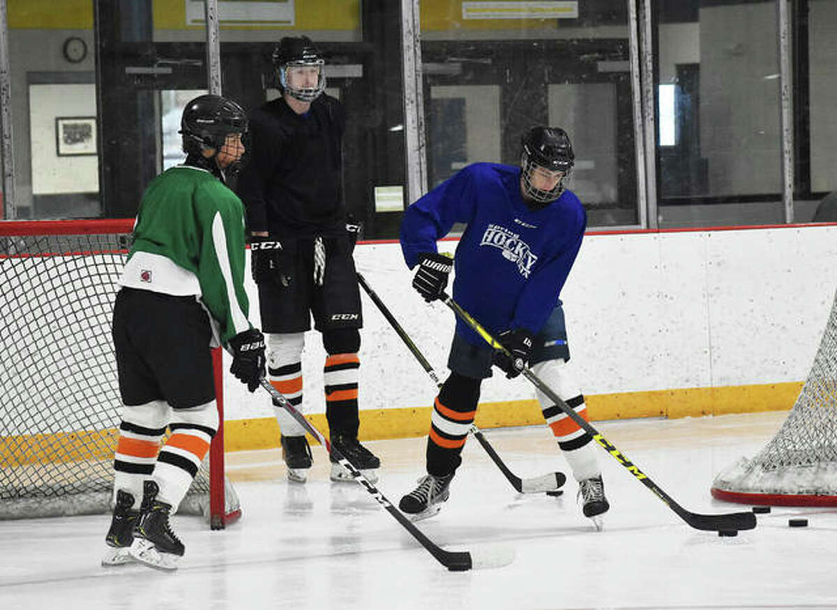 Three members of the EHS ice hockey team run through a drill earlier this summer inside the East Alton Ice Arena.