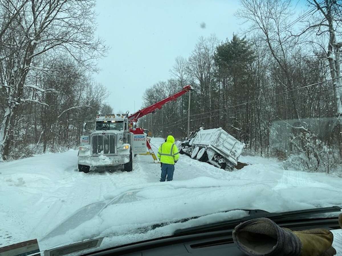 A tow truck hauls town plow out of ditch on Fort Edward Road on Thursday, Dec. 17.