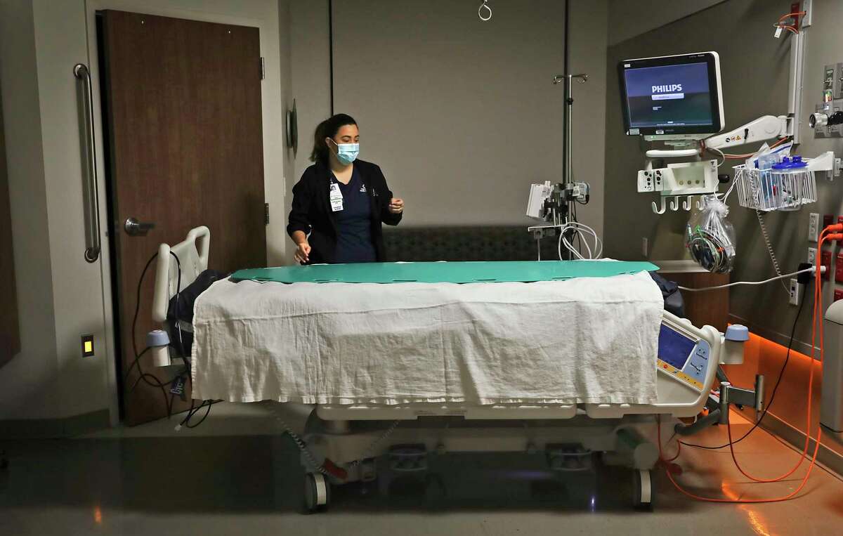Gomez checks a room before a COVID-19 patient arrives.