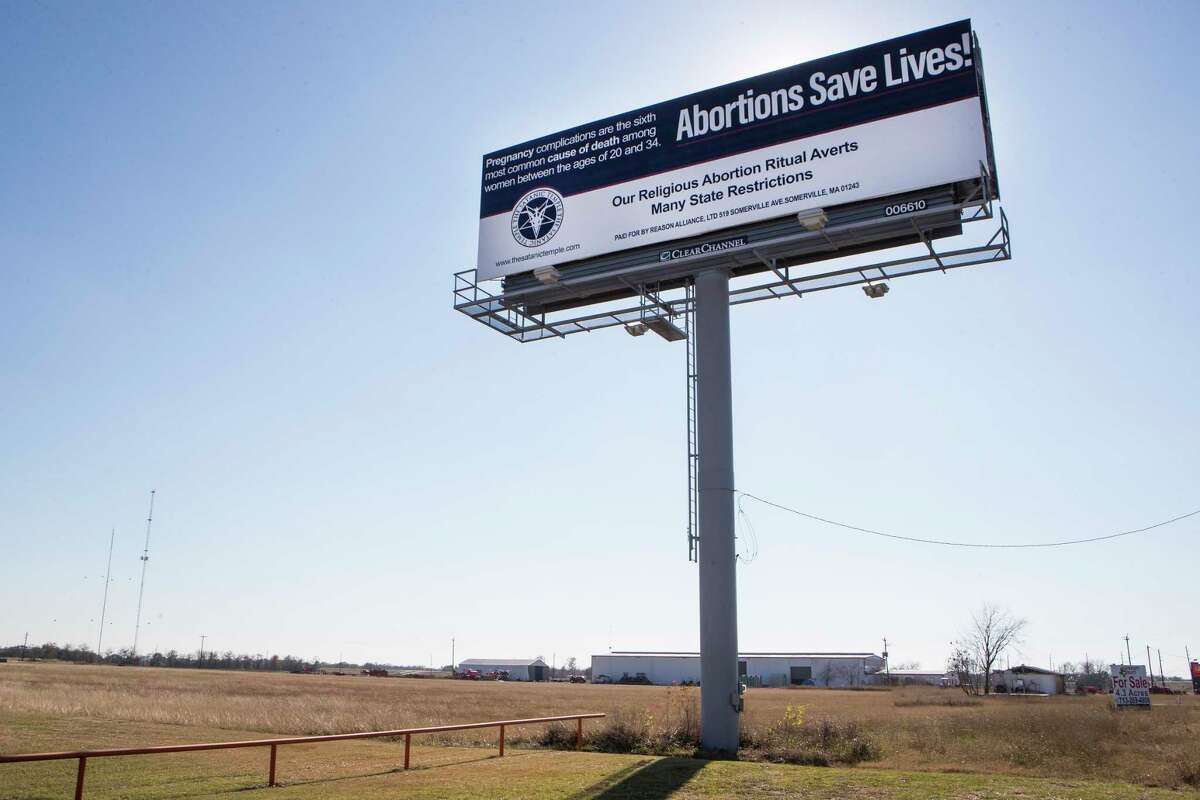 A billboard along the US69 reads "Abortions save lives!" Thursday, Dec. 17, 2020 in Rosenberg. The billboard, erected by the Satanic Temple in Houston, is one of three that the group has put up near crisis pregnancy centers in three major American cities. The billboards, which went up Dec. 14, are part of the advocacy group's protest of exemptions granted to other religions.