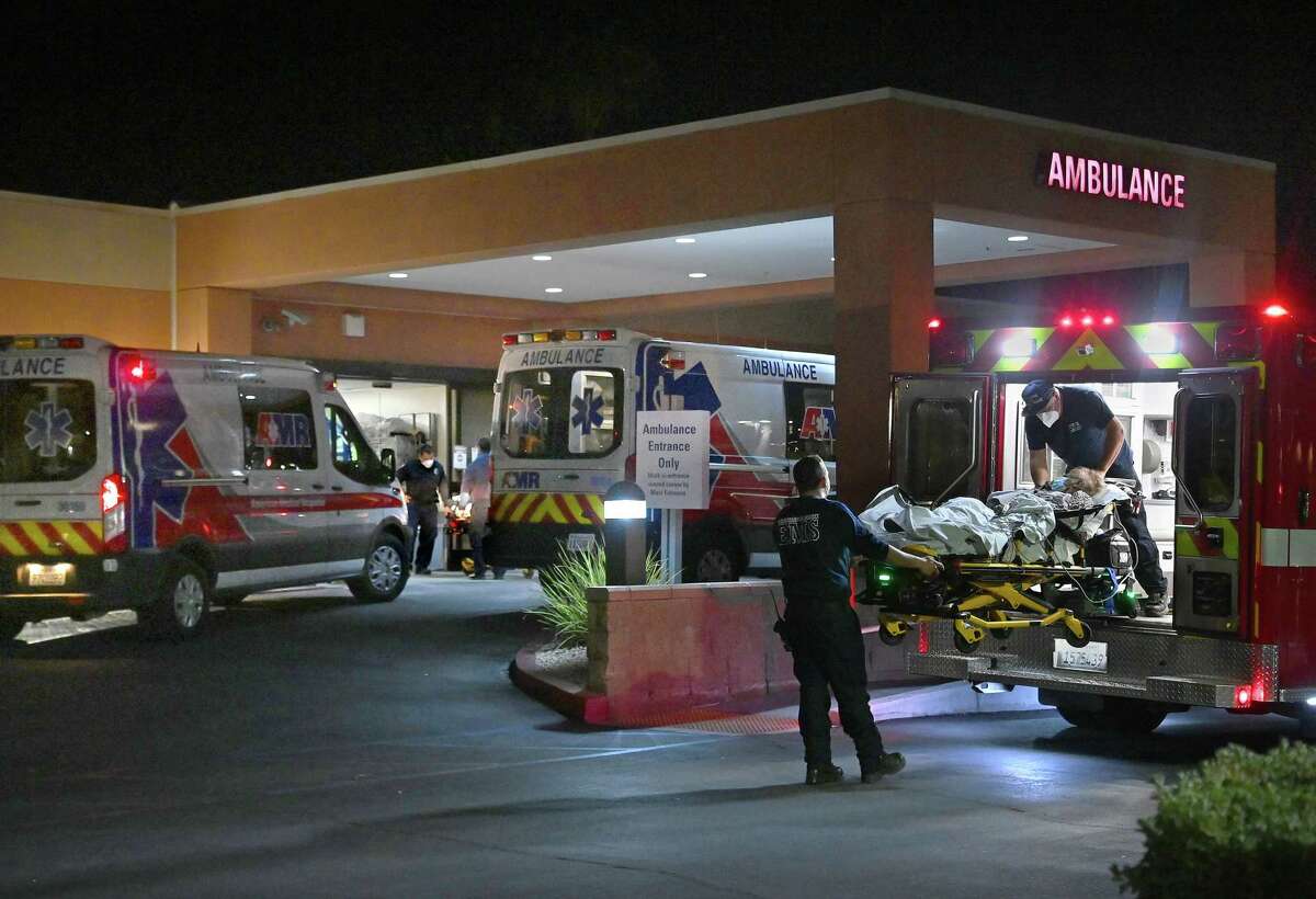 Ambulances arrive at the St. Mary Medical Center in Apple Valley, Calif. on Dec. 13, 2020.