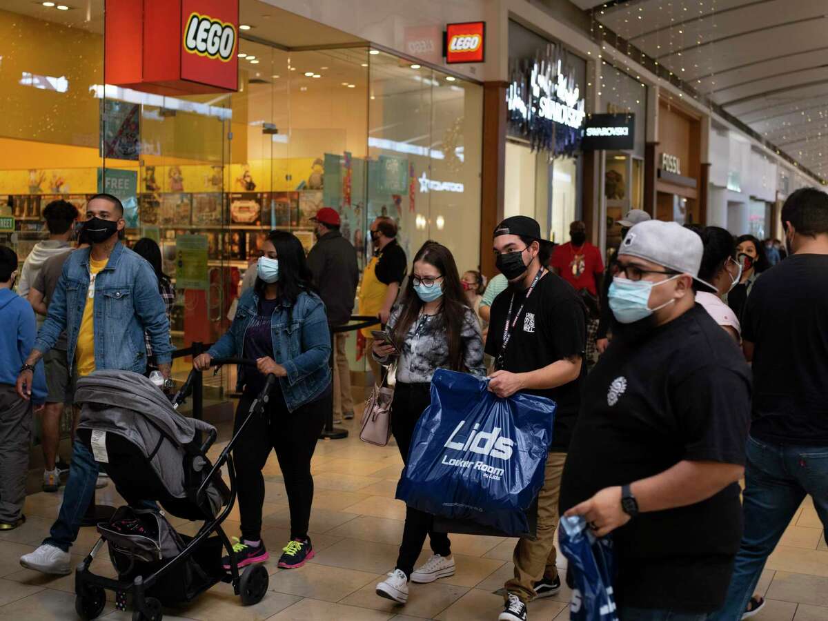 Holiday shoppers make their way through North Park Mall. Retailers and mall owners are offering new programs to help patrons avoid lengthy waits while helping stores maintain occupancy limits.