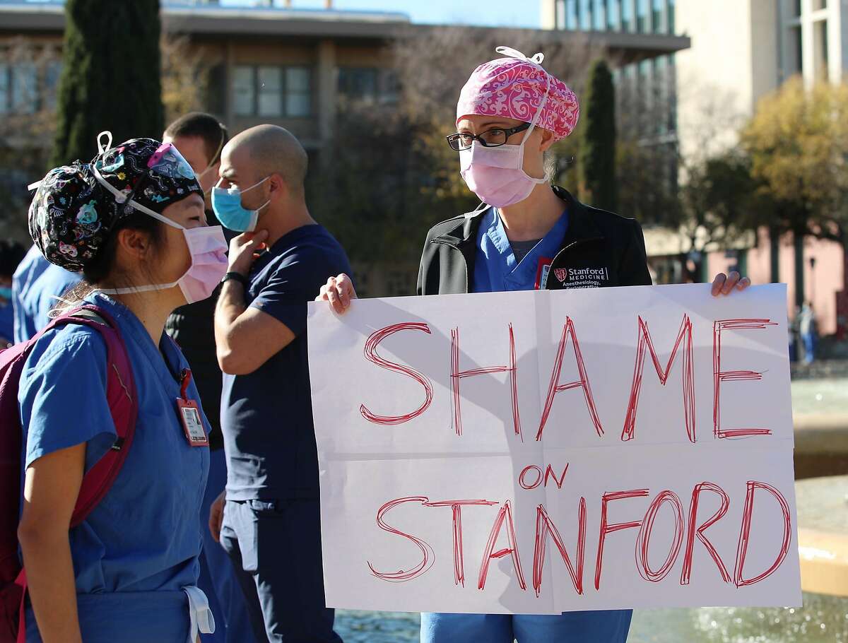 Deborah Fretwell holds a sign during a protest at the Stanford University Medical Center on Friday.