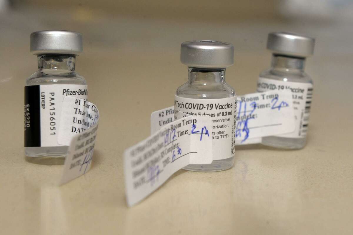 Three vials of the Pfizer COVID-19 vaccine at Stamford Hospital, in Stamford, Conn. Dec. 17, 2020.