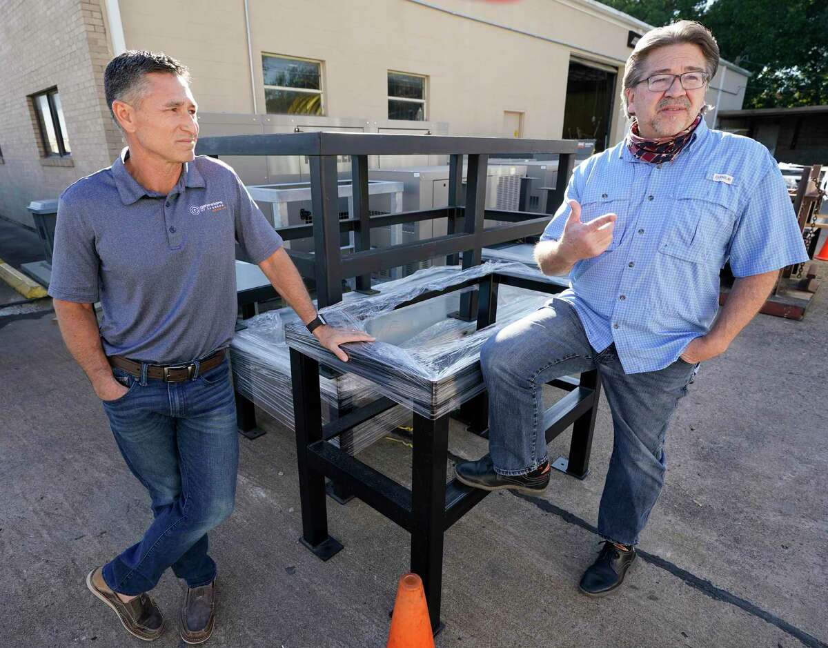 Todd Manchaca, general manager, left, and Dan Tragni, vice president, right, talk near the generator risers at Generators of Houston, 6106 Milwee St., Wednesday, Nov. 18, 2020 in Houston. A mix of bad weather, electricity unreliability, working from home and fears of social unrest have encouraged more homeowners to install standby generators.