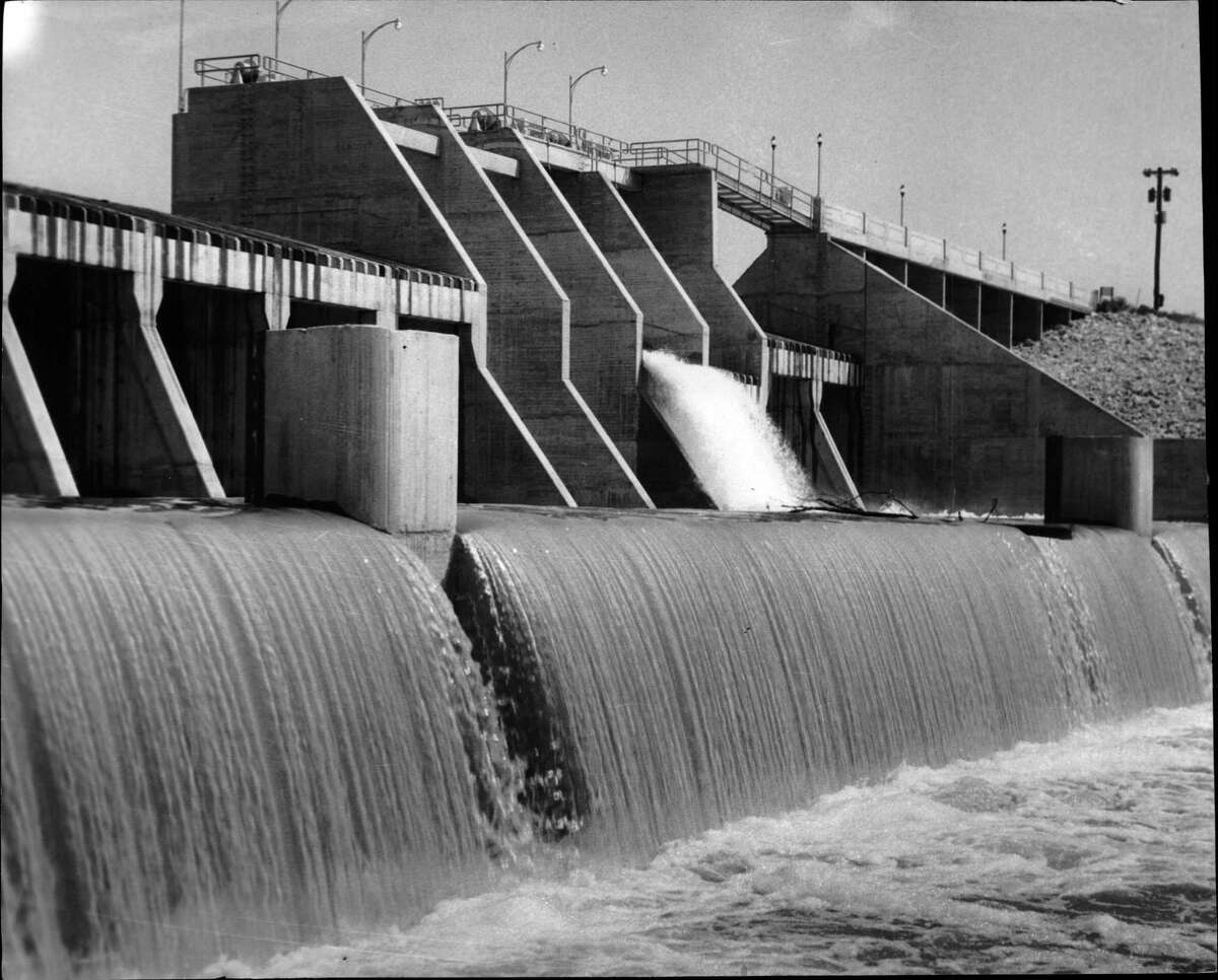 1956 - Water pours over San Jacinto Dam out of Lake Houston. Completed in 1955 on the San Jacinto River, the lake at capacity is 12,500 acres big and holds 52 billion gallons of water. The lake has developed into a playground as well as a reservoir for the city of Houston.