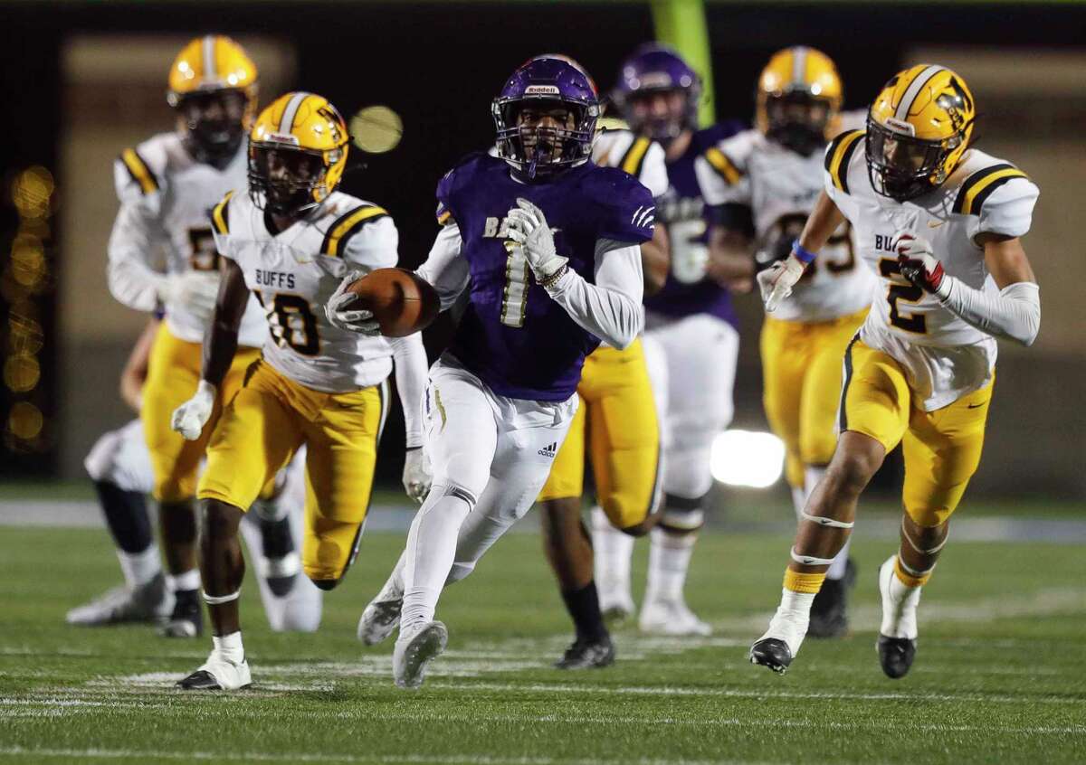 Montgomery running back Jalen Washington (1) runs for a 52-yard touchdown during the fourth quarter of a Region III-5A area high school playoff football game at Randall Reed Stadium, Friday, Dec. 18, 2020, in New Caney. Fort Bend Marshall defeated Montgomery 48-28.