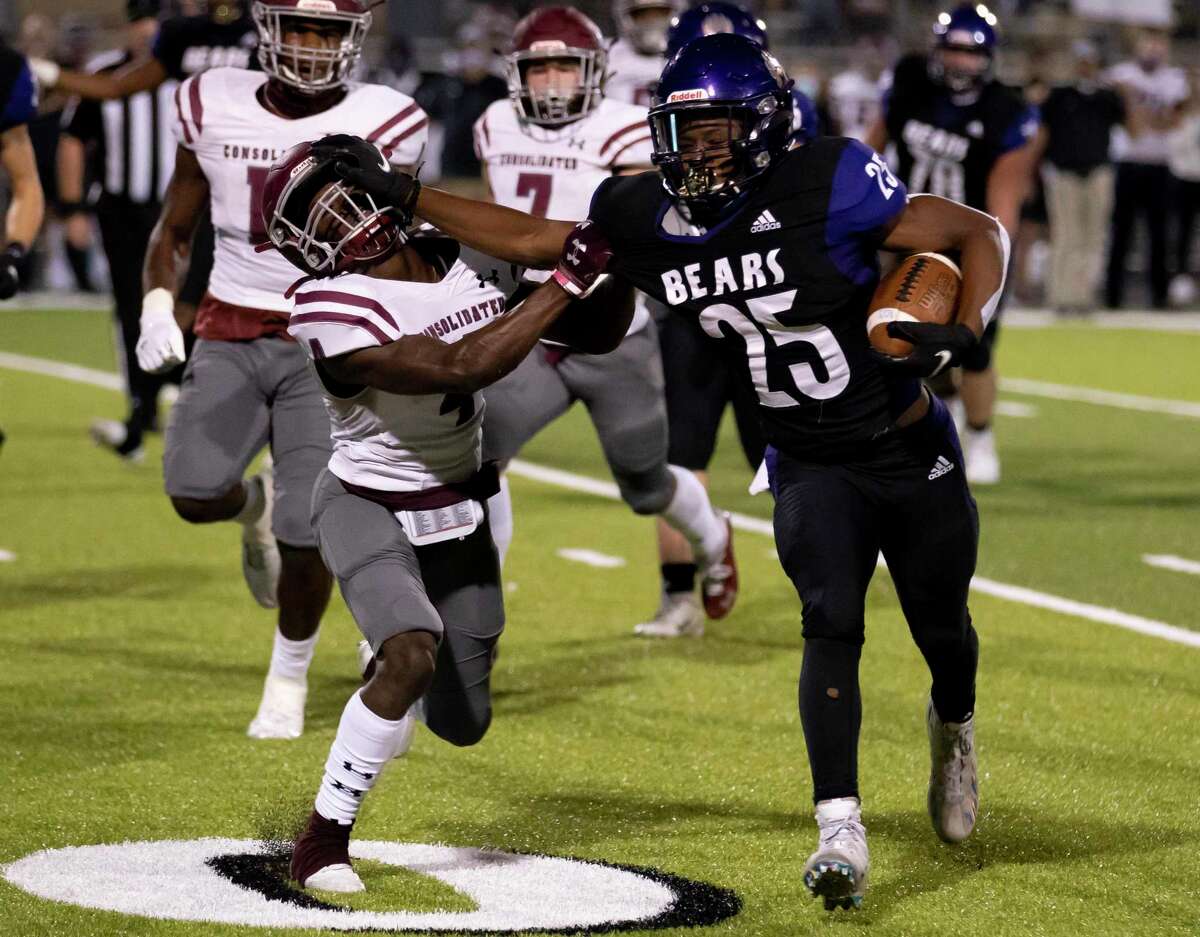 Montgomery running back Adavion Johnson (25) pushes off A&M Consolidated player Jaylon Walter (4) during the second quarter of a District 10-5A (Div. II) football game at Montgomery ISD Stadium on Friday, Nov. 13, 2020.