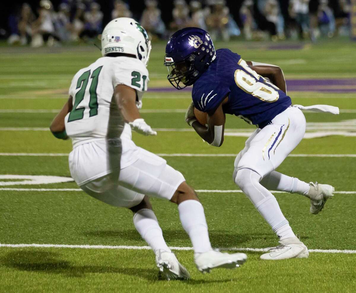 Montgomery wide receiver Tre Harden (85) runs the ball while pressured from Huntsville safety Jarrett Ortega (21) during the first quarter of a District 10-5A (Div. II) football game at Montgomery ISD Stadium, Friday, Nov. 27, 2020, in Montgomery.