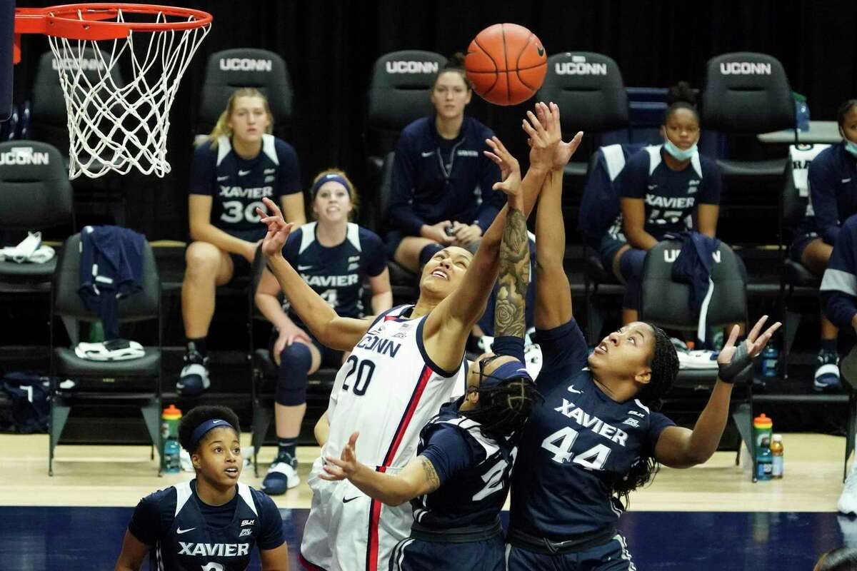 UConn’s Olivia Nelson-Ododa (20) and Xavier forward Ayanna Townsend battle for a rebound during the first half Saturday in Storrs.