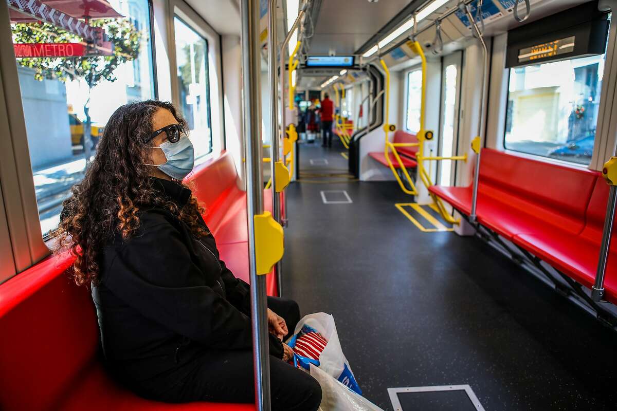 Alexis Laguillo rides Muni’s J-Church streetcar after it resumed service Saturday. “I love the J being back,” she said.