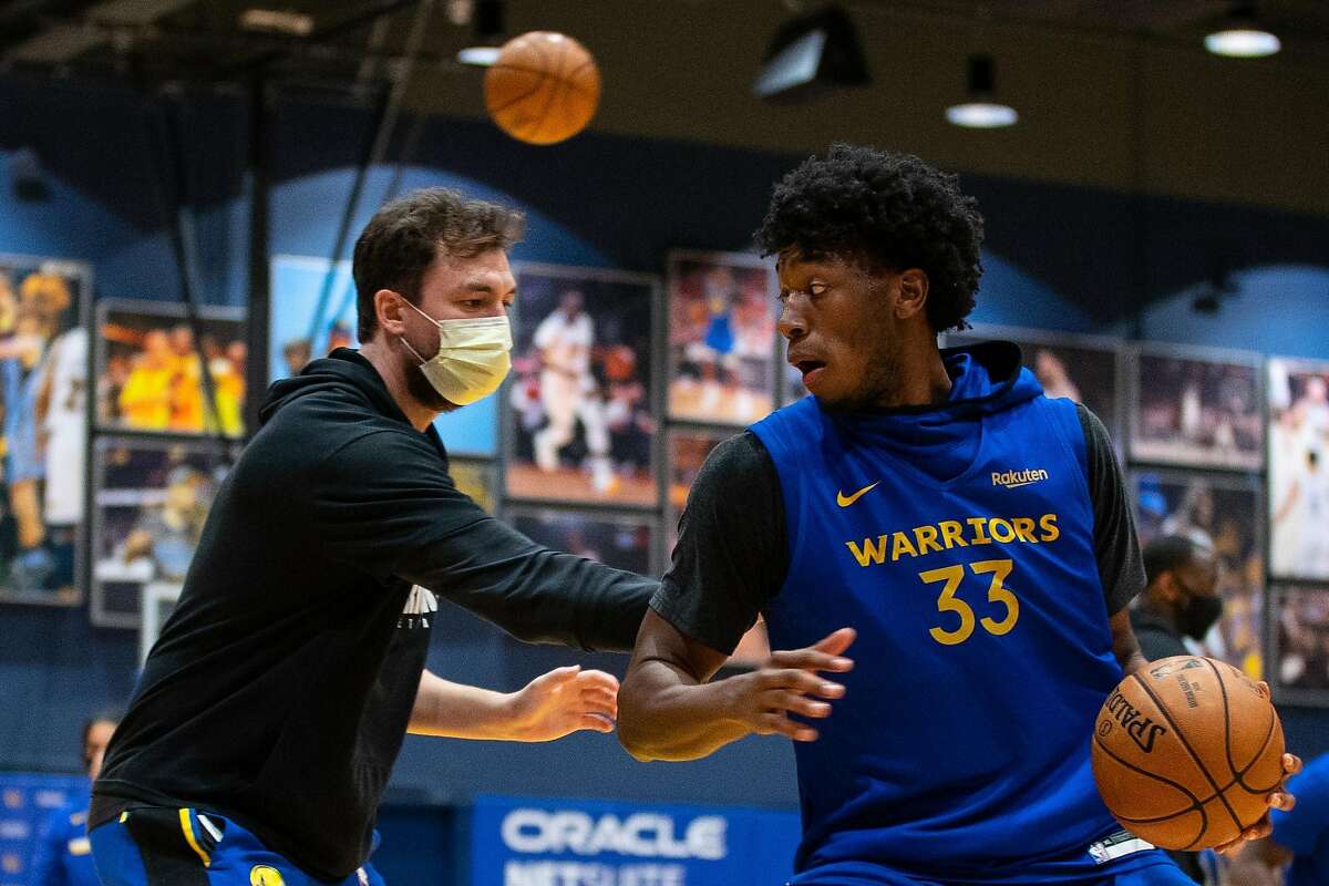 Golden State Warriors Player Development Coach Chris DeMarco (left) guards Warriors rookie James Wiseman (right) at practice at Chase Center on Wednesday, December 16, 2020.