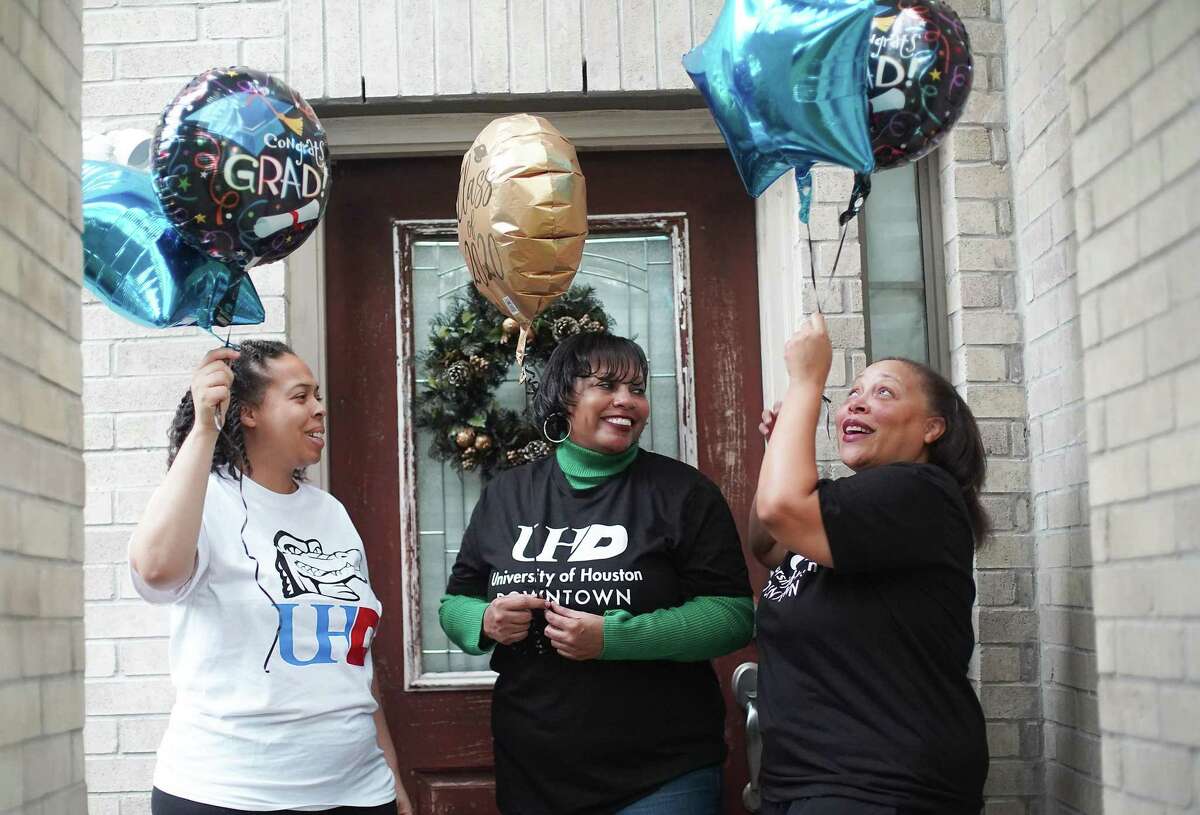 Lampkin sisters: Tiffany, 36 (from left), Zanda, 50 and Erneka, 43, pose for a photo outside Erneka's home in Cypress on Saturday, Dec. 19, 2020. The three will be graduating imultaneously during a virtual commencement ceremony from the University of Houston Downtown