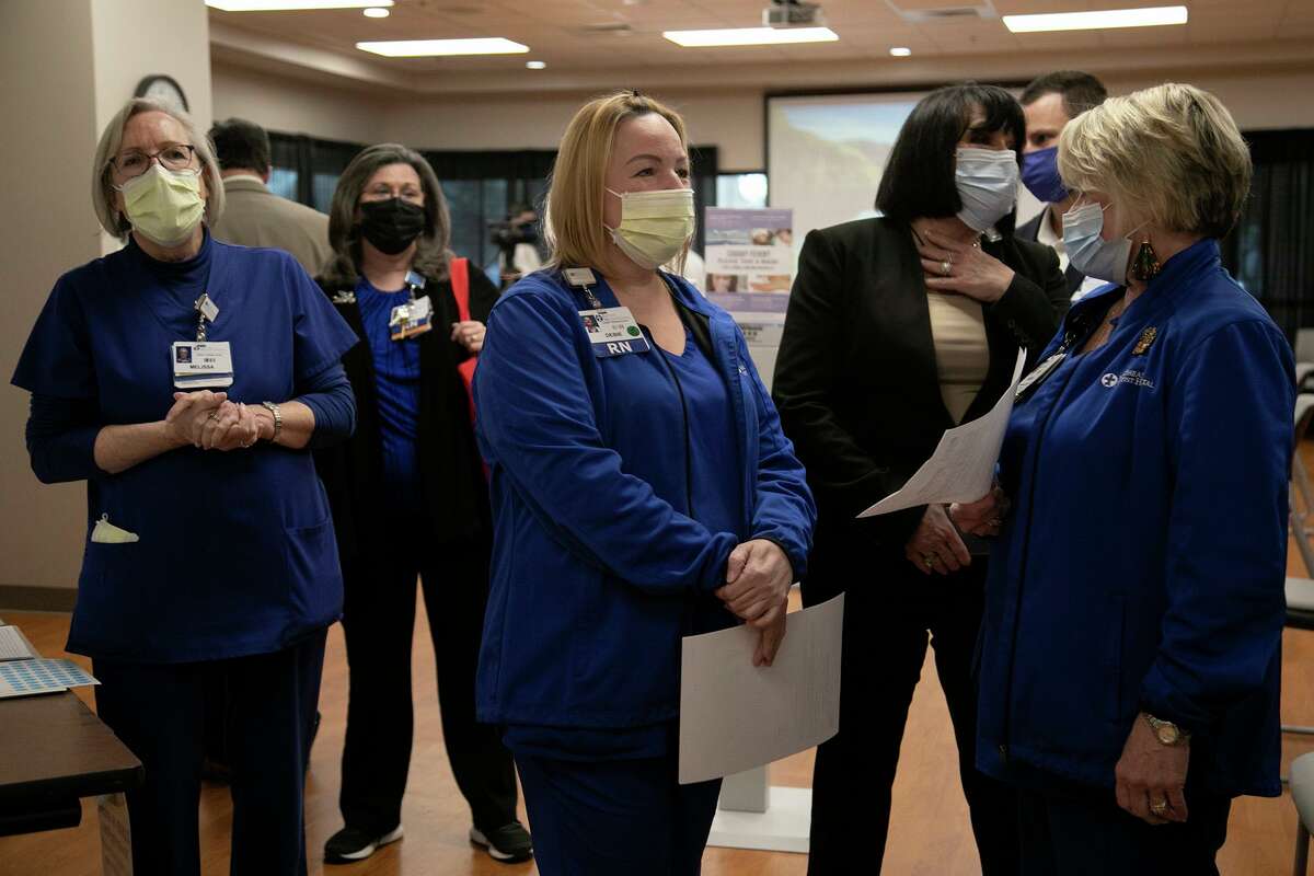 Melissa Wyatt, from left, RN and occupational health nurse, watches COVID-19 vaccines being administered as RN and nursing director Debbie Kelly and Vanessa Magel, RN and administrative director of acute and intermediate services, wait their turn for the vaccine at Northeast Baptist Hospital in San Antonio on Dec. 17, 2020.