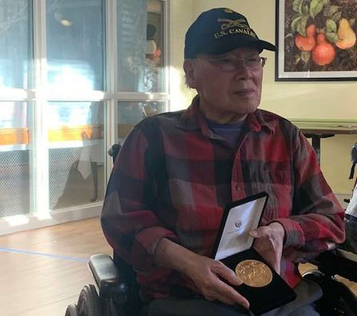 Wilton Meadows Chuck Eng holds the gold medal he was awarded Dec. 11, by the Chinese American Citizens Alliance for his service in the U.S. Army during World War II.