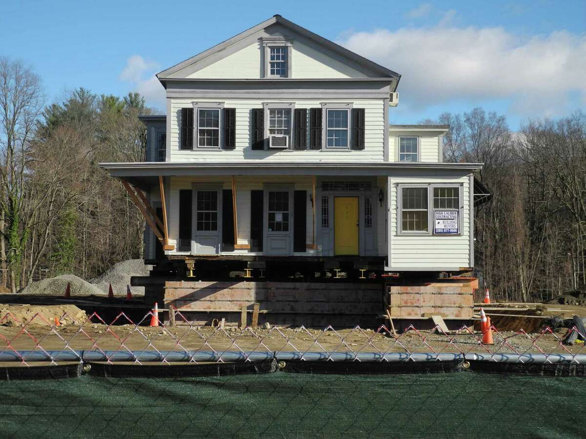 The development 200 Sharp Hill Square was created around preserving the historic Raymond-Morehouse House, which was the former Sheridan Interiors furniture store. On Dec. 10, the building is ready to be moved on the building site. Two buildings combining residential and retail will be built at the Danbury Road property.