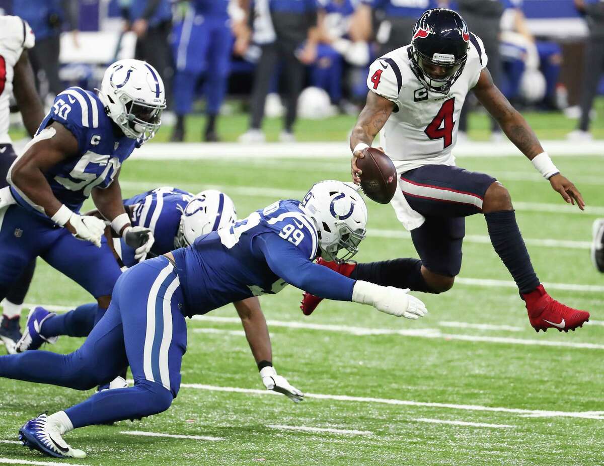 Houston Texans quarterback Deshaun Watson (4) leaps as he is hit by Indianapolis Colts defensive tackle DeForest Buckner (99) during the fourth quarter of an NFL football game at Lucas Oil Field Sunday, Dec. 20, 2020, in Indianapolis. Watson lost his balance on the play and was sacked.