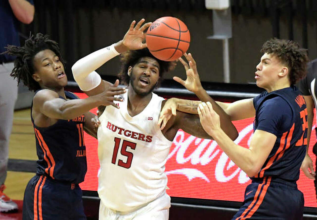 Rutgers’ Myles Johnson (15) is pressured by Illinois guards Ayo Dosunmu (left) and Coleman Hawkins during the first half Sunday in Piscataway, N.J.