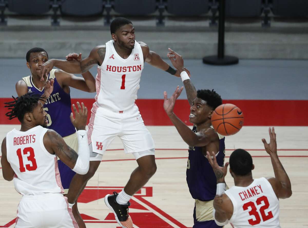 Houston Cougars guard Jamal Shead (1) passes the ballot forward Reggie Chaney (32) during the first half of an NCAA men's basketball game at Fertitta Center Sunday, December 20, 2020, in Houston.