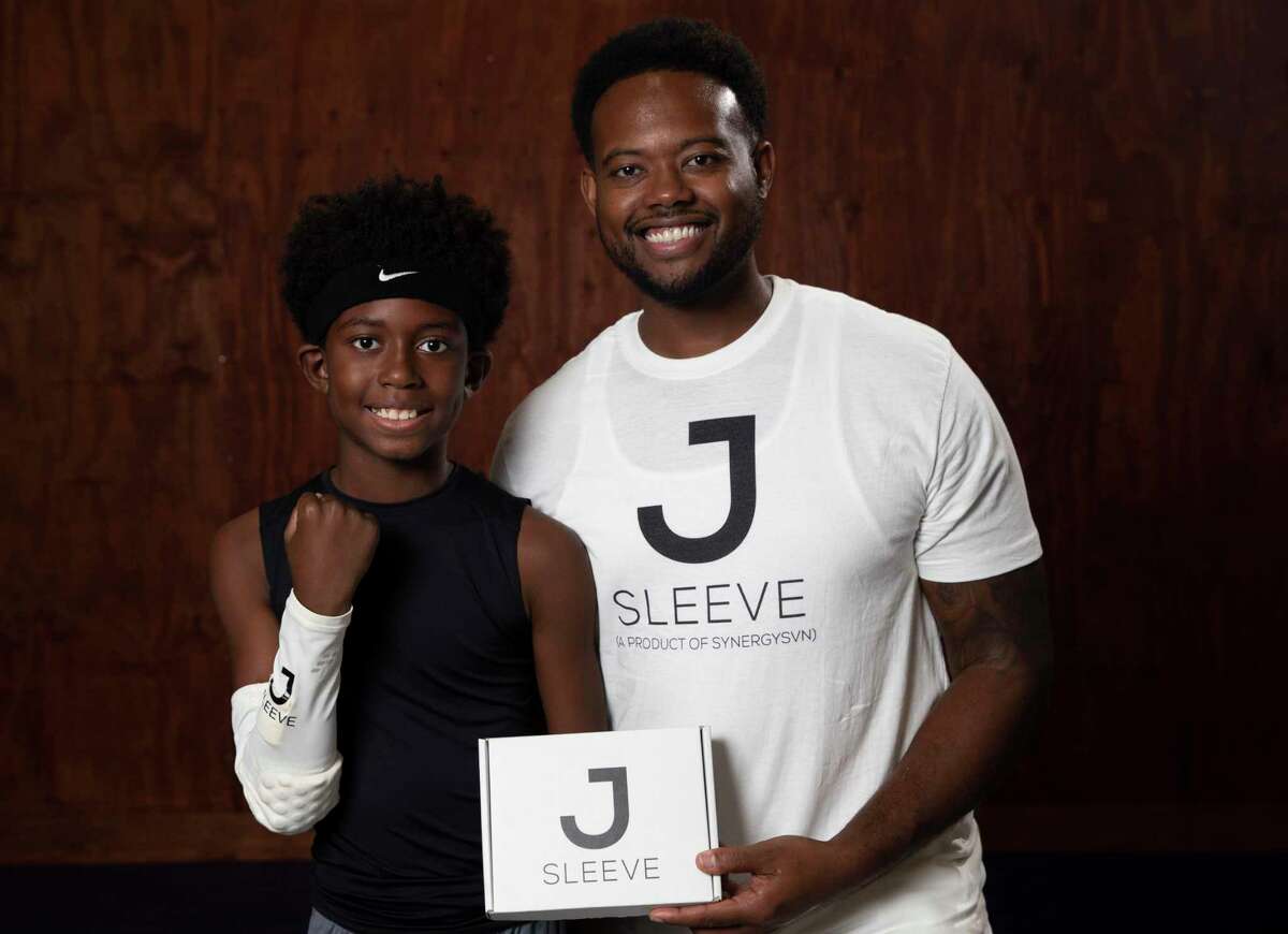Jeremy Henderson, 37, CEO of Synergy7 and the maker of the JSleeve, and his son, Luke Henderson, 10, pose for a photograph Friday, Nov. 20, 2020, at former NBA player Brian Skinner's Texas Outlaws Basketball Gym in Fulshear. Jsleeve is a sensor-filled sleeve that basketball players wear to help with shooting form.