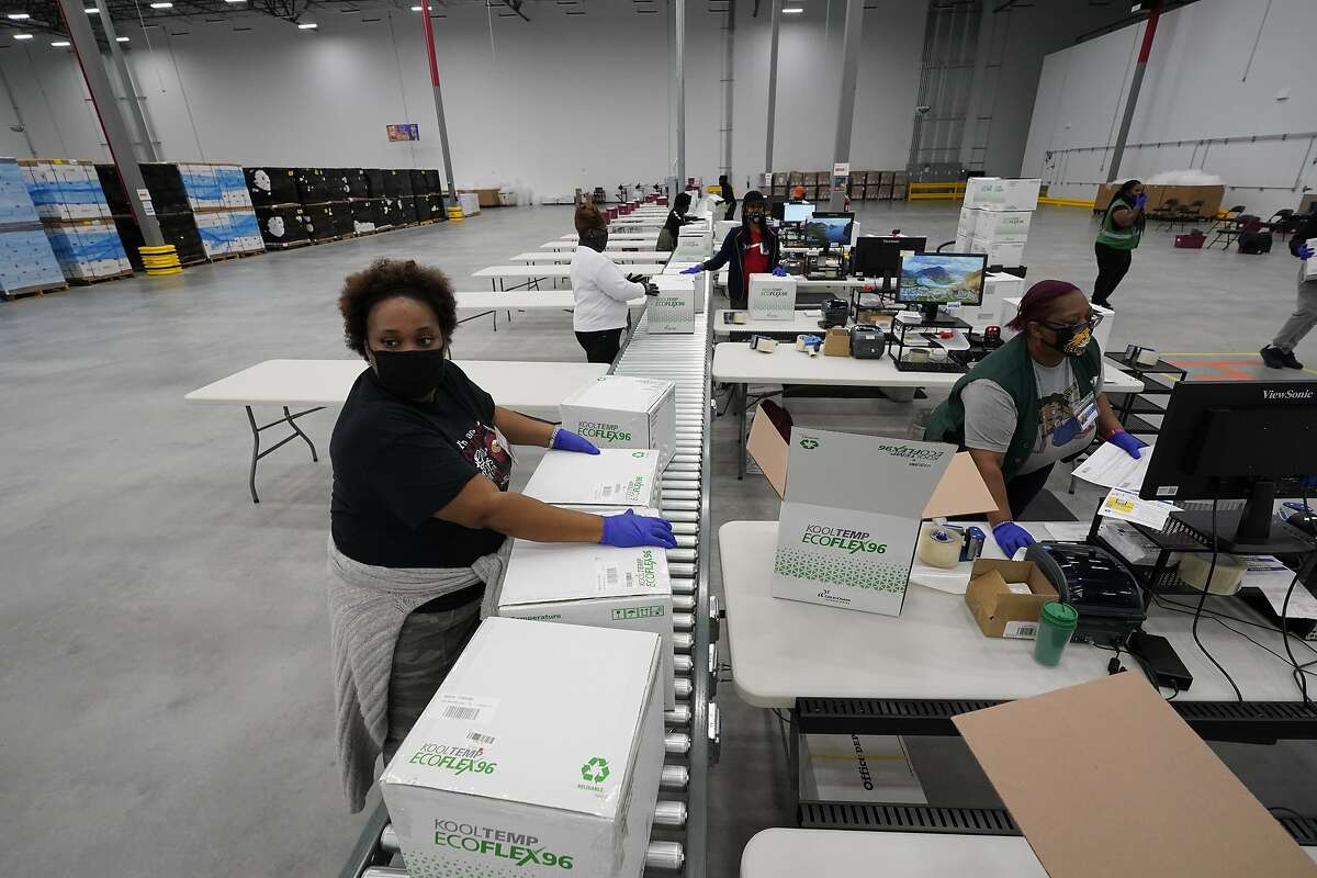 Boxes containing the Moderna COVID-19 vaccine are prepared for shipment at the McKesson distribution center in Mississippi on Sunday. The Moderna vaccine could reach the Bay Area as soon as Monday.