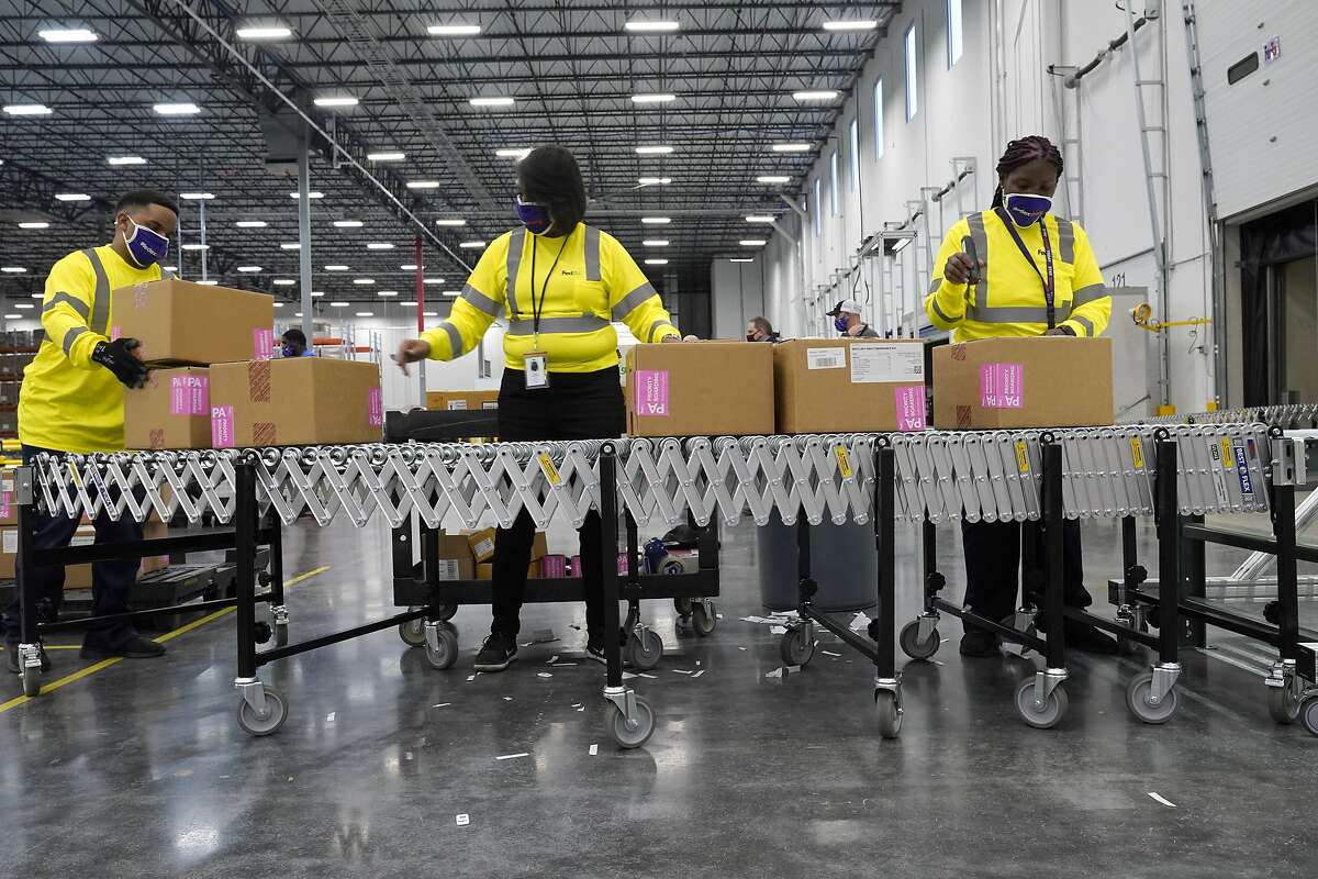 Boxes containing the Moderna coronavirus vaccine are prepared to be shipped at a McKesson distribution center in Mississippi on Sunday.