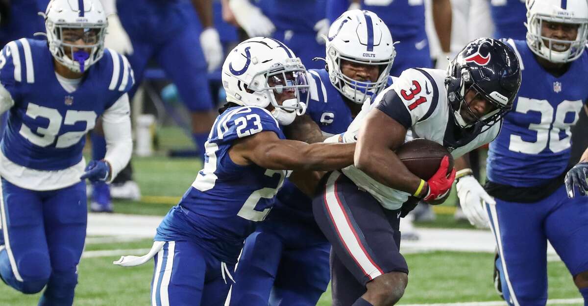Houston Texans running back David Johnson (31) is stopped by Indianapolis Colts cornerback Kenny Moore II (23) during the third quarter of an NFL football game at Lucas Field Sunday, Dec. 20, 2020, in Indianapolis.