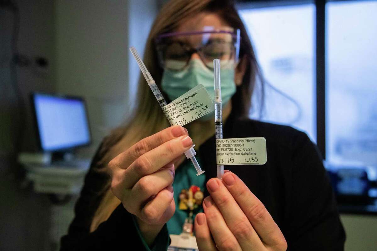 Baylor St. Luke’s Medical Center registered nurse Linda Fletcher holds Pfizer COVID-19 vaccines on the first day Baylor St. Luke’s Medical Center start immunizing their staff, Tuesday, Dec. 15, 2020, in Houston.