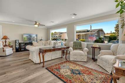 8 Spring Lane. Morgan Hill, CA PRICE: $459,000 DESCRIPTION: Prepare to fall in love. Discover a new lifestyle at this resident-owned Woodland Estates senior community! The welcoming entryway with a new front door leads to beautifully renovated home! You'll want to linger in the large open space that invites you to sit down and relax. Open sunny floor plan. Prepare meals in the well-appointed chef's kitchen! Custom cabinets, gas cooktop w/hood, built-in oven and convection microwave, quartz countertops, and undercabinet lighting. Enjoy your morning coffee at the gracious island breakfast bar. Laminate flooring throughout. The master bathroom features a walk-in shower and dual sink vanity. The laundry room is outfitted with ample custom cabinetry. This home has been tastefully designed and has dual pane windows, newer furnace & a/c, ceiling fans, LED can lighting, fully sheetrocked and textured, crown molding in every room, new PEX/Copper plumbing, and a newer roof. Private rear patio and room for a garden. So much to appreciate here! SIZE: 1440 square feet BEDROOMS: 2 MLS ID: 81840244 AGENT: Jennifer Doak BROKERAGE: Intero Real Estate Photos and listing copyright 2021 by Intero Real Estate and associated MLS.