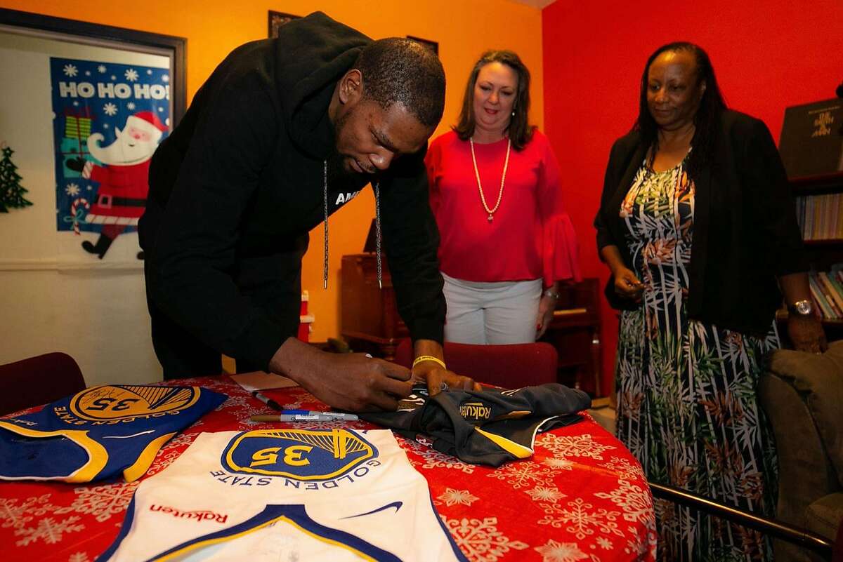 For about an hour, Durant handed presents to moms and their children, posed for pictures and signed autographs before writing a check to the organization for more than $15,000.