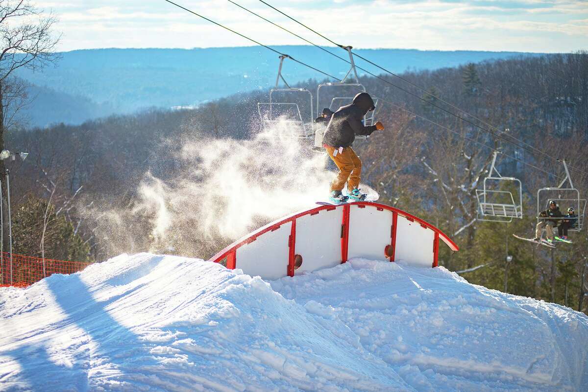 A snowboarder rides the rail at Ski Sundown in Cornwall.