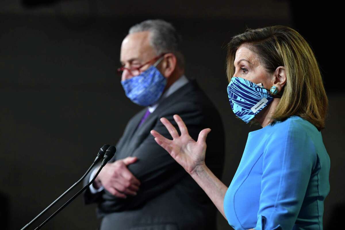 (FILES) In this file photo US Speaker of the House, Nancy Pelosi (R), Democrat of California, and Senate Minority Leader Chuck Schumer, Democrat of New York, hold a press briefing on Capitol Hill in Washington, DC, on November 6, 2020. - As lawmakers inch closer to a new stimulus package to help the pandemic-battered US economy, government data shows more workers are applying for unemployment benefits as the recovery stalls. A government relief package to aid struggling businesses and jobless workers is seen as essential in getting the world's largest economy back on its feet amid a resurgence of Covid-19 infections, even as new vaccines offer hope that life can return to normal.Without an agreement, millions of unemployed workers will lose their special pandemic benefits before the end of the year.Democratic leaders House Speaker Nancy Pelosi and Senator Chuck Schumer held talks with Treasury Secretary Steven Mnuchin late into the night on December 16, 2020, and were due to speak again early December 17, 2020, Pelosi's deputy chief of staff Drew Hammill said. (Photo by Nicholas Kamm / AFP) (Photo by NICHOLAS KAMM/AFP via Getty Images)