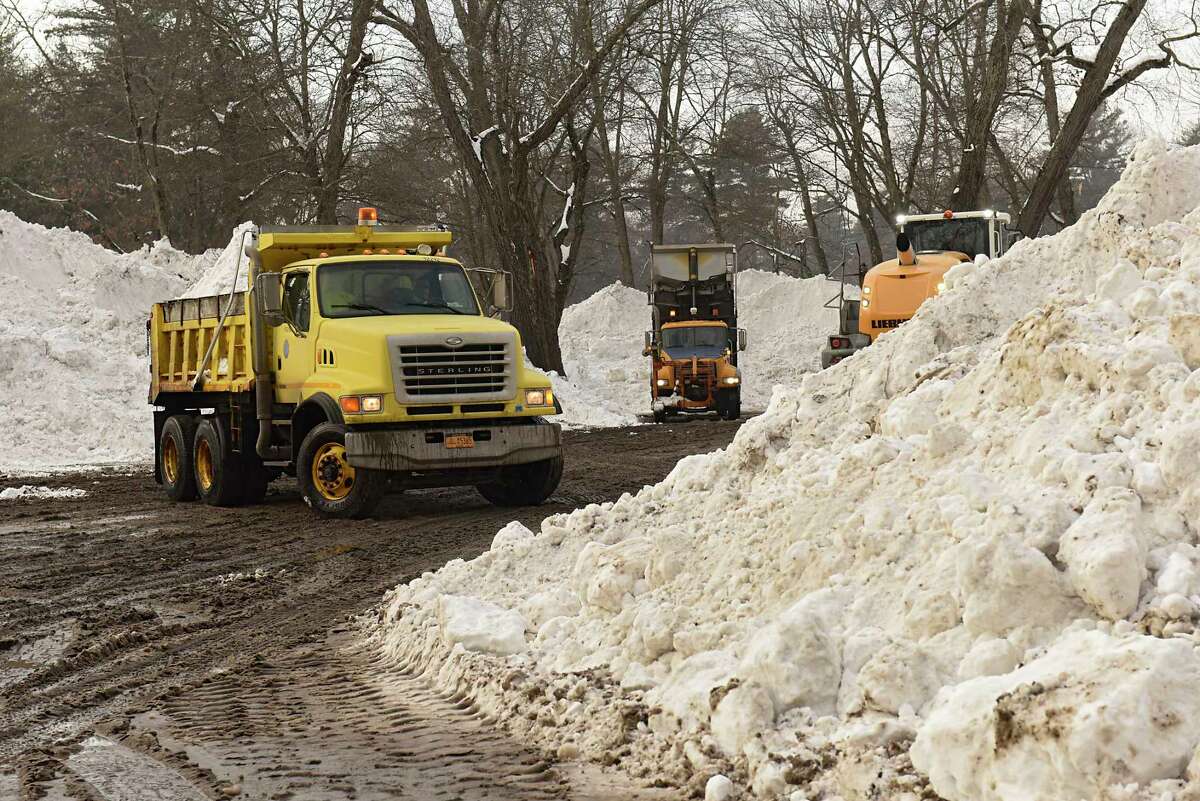 State and local crews dump snow in a parking lot across from the intersection of Golf Rd. and Fehr Ave. at Central Park on Monday, Dec. 21, 2020 in Schenectady, N.Y. (Lori Van Buren/Times Union)